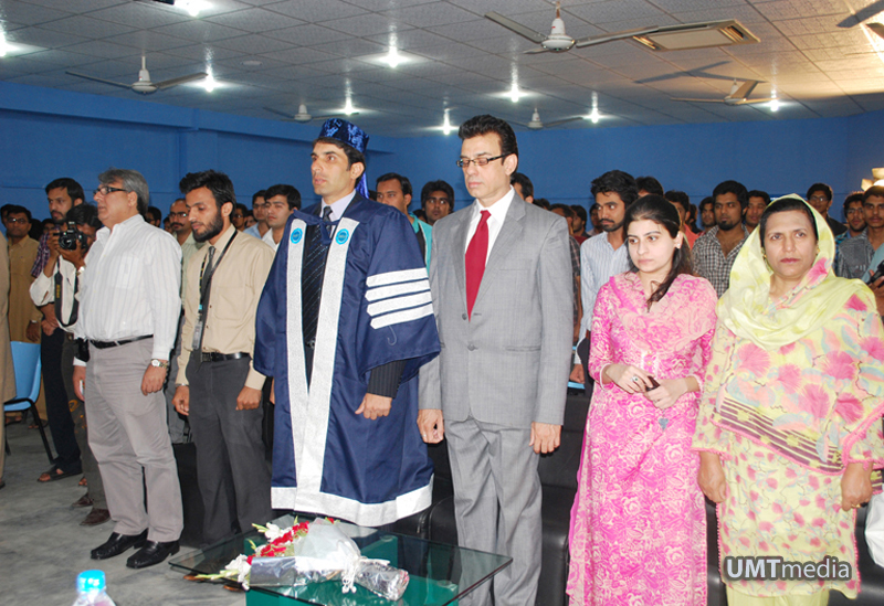 Audience rise from their seats as the national anthem is played