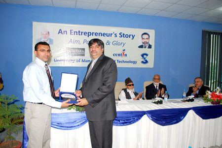 Rashid Hussain, Director CENTIN, presents UMT souvenir to Mian Javed Iqbal, Director, Sitara Group